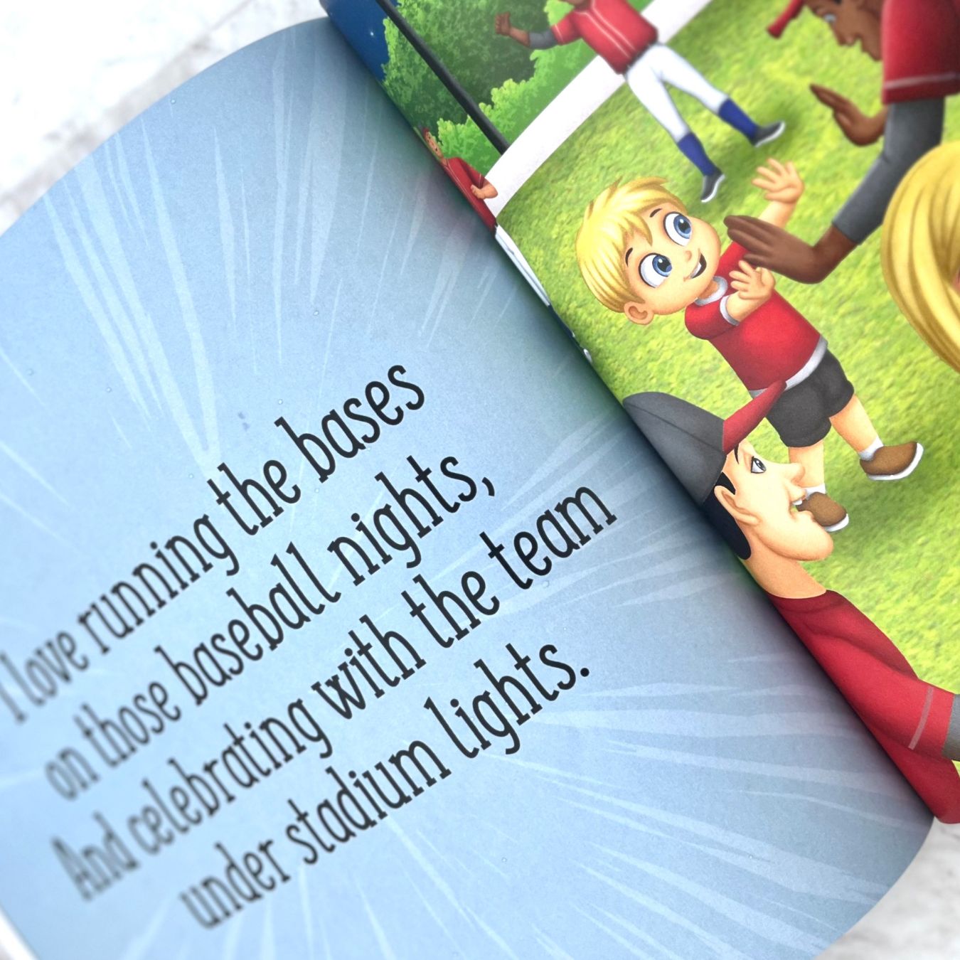 open page of baseball kids book with vibrant pages of kids with baseball players